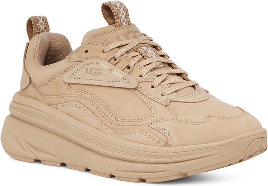 Beige UGG sneaker with patterned heel pull and side logo.