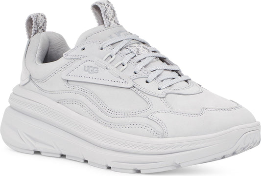 A white leather UGG trainer with a chunky sole and matching laces.