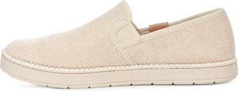 Beige canvas slip-on shoe with a white sole.