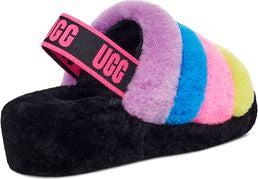Black slipper with a strap that says UGG, and a colorful rainbow foot insert.