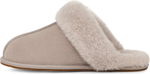 A side view of a light grey suede slipper with a faux fur trim.