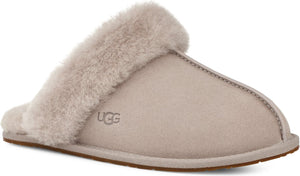 Light grey slipper with fur trim and the letters UGG on the side