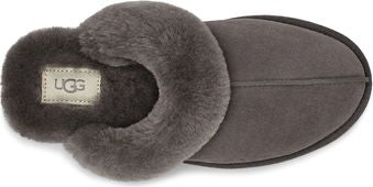 Overhead view of a gray, suede, closed-toe slipper with gray faux fur lining around the foot opening and heel; the UGG brand is on the insole.