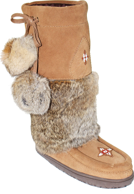 A tall, brown moccasin boot with decorative fur trim and fluffy pom-poms.