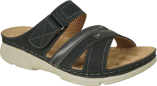 Black sandal with white stitching, an adjustable velcro strap, a cross strap with silver detail, and a light tan sole.