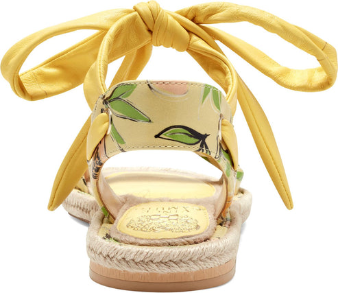 Yellow sandals with ankle tie straps and floral pattern.