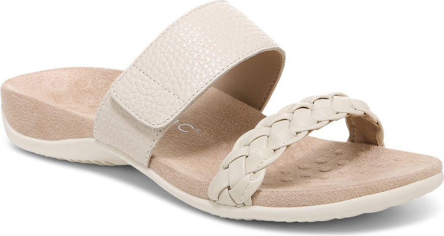 Cream sandal with hook and loop strap over the arch and a braided toe strap.