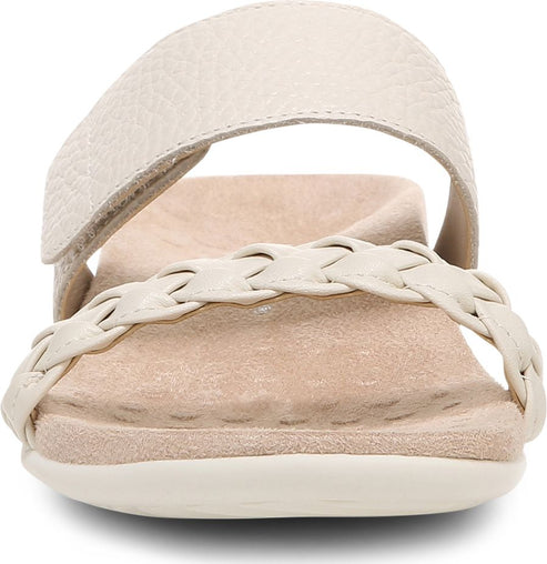 Front view of a flat, cream-colored sandal with a braided strap and an adjustable, buckled top strap.