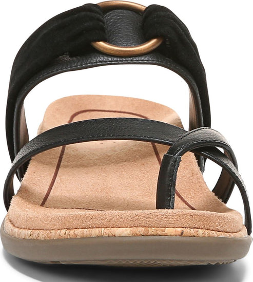 Close-up of a black sandal with toe loop and metallic ring detail.