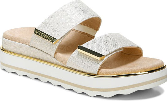 Two-strap platform sandal with gold hardware and a wavy sole.