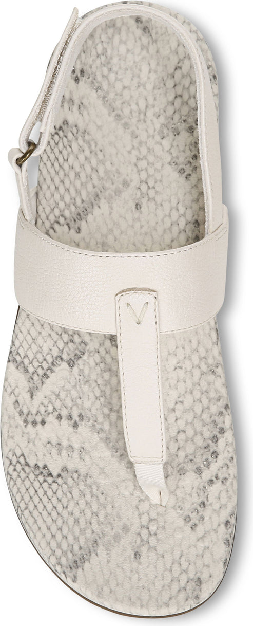 A white sandal with a snakeskin pattern.