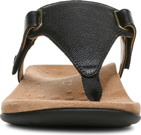 Close-up of a black sandal with thong-style toe post, black sole and beige footbed.