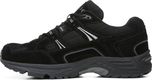 A black athletic shoe with suede and mesh upper, a gray sole, and white accents.