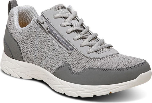 Gray sneaker with textured pattern, side zipper and white sole.