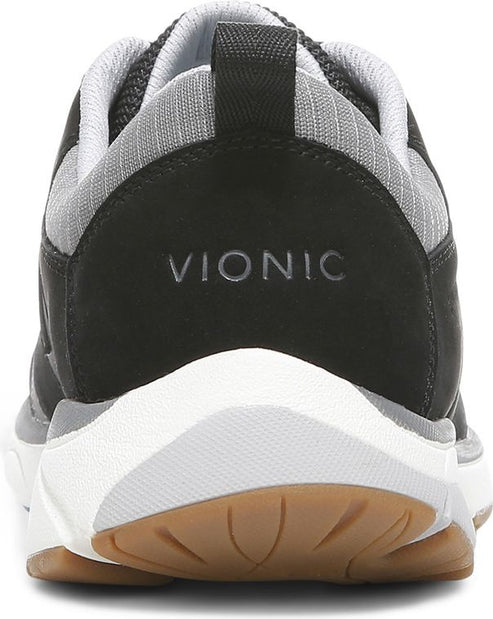 A shoe's rear features a white sole, brown tread, and VIONIC stitched at the top.