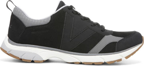 A black and gray athletic shoe with a white sole and brown bottom.