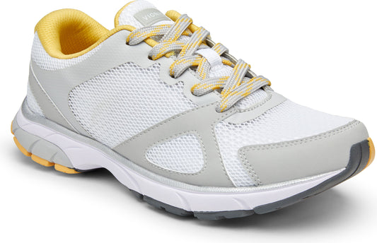 White sneaker with light gray accents and yellow lining and laces.