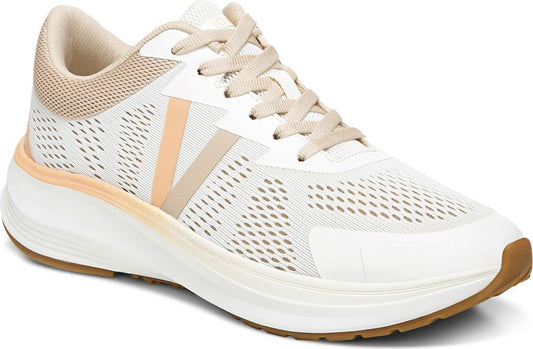 A low profile athletic shoe with white perforated synthetic upper, beige laces, peach and beige accents, and a thick white midsole.