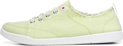 A light green sneaker with white laces and a white sole.