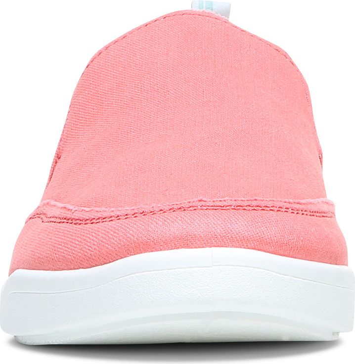 A close-up of a pink canvas slip-on shoe with a white sole, viewed from the front.