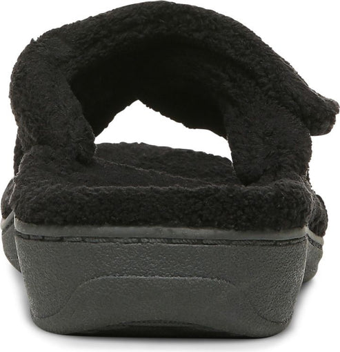 Rear view of a black, fluffy slipper with a slight wedge heel.