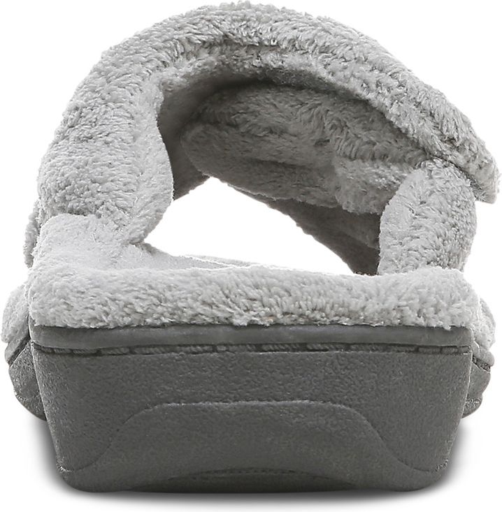 Close-up of a gray slipper with a soft, furry upper and thick, dark gray sole.