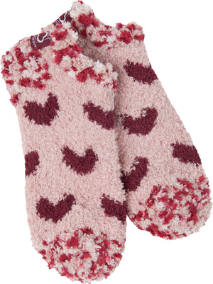 Pair of fuzzy socks with heart and spotted patterns in pink and maroon hues.
