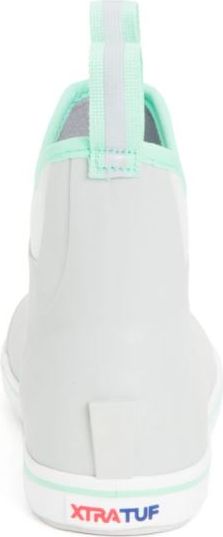 Back view of a white shoe with a pull tab at the back of the heel and the text XTRATUF at the bottom.